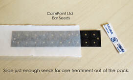CalmPoint Ear Seed pack open showing ear seeds inside.